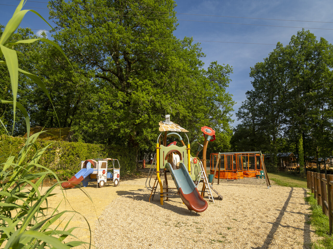Children's playground, slides, swings at CLICOCHIC Linotte campsite, Le Bugue.