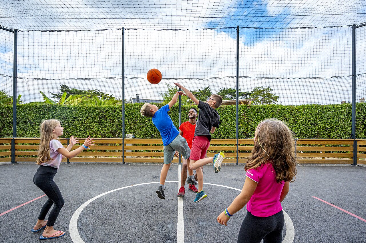 Kinder spielen Basketball auf Multisportplatz auf Camping CLICOCHIC Longchamp in Saint Lunaire (35).