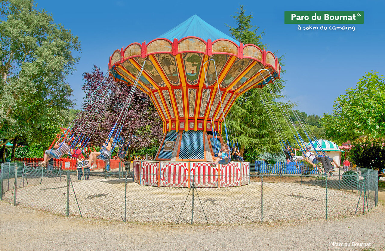 Traditional swing carousel at Parc du Bournat, family attraction near the campsite.