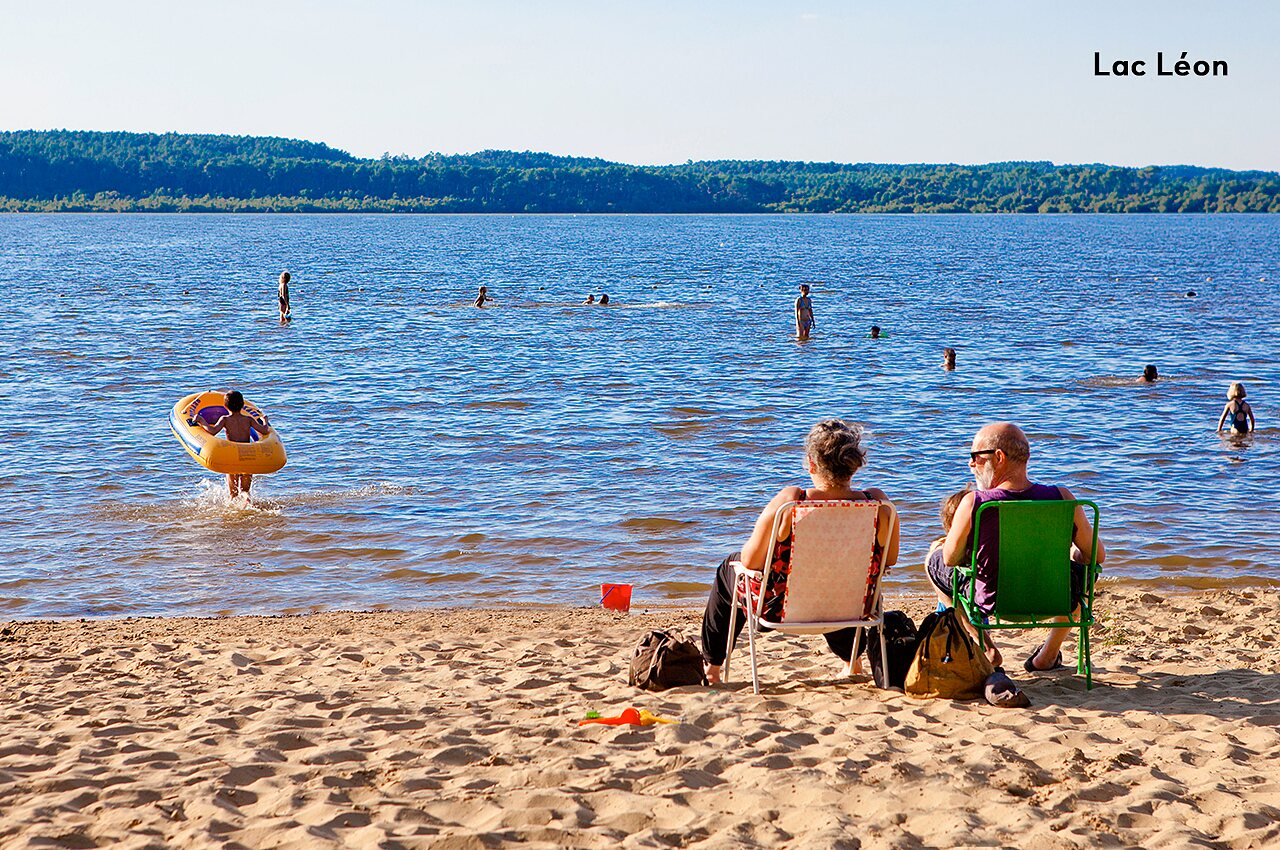 Lac L�on beach with swimmers and families relaxing, near L�on.