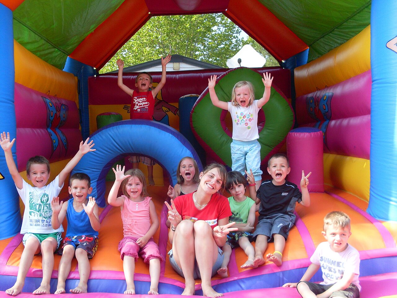 Happy children playing in a colorful bouncy castle at CAPFUN Lou Puntaou campsite in LEON (40).