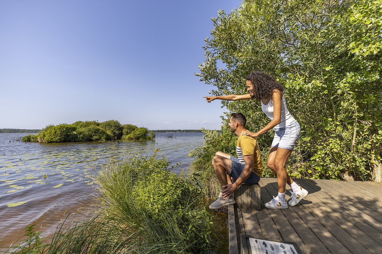 Couple observing lake and lush nature at CAPFUN Lou Puntaou campsite in LEON (40).