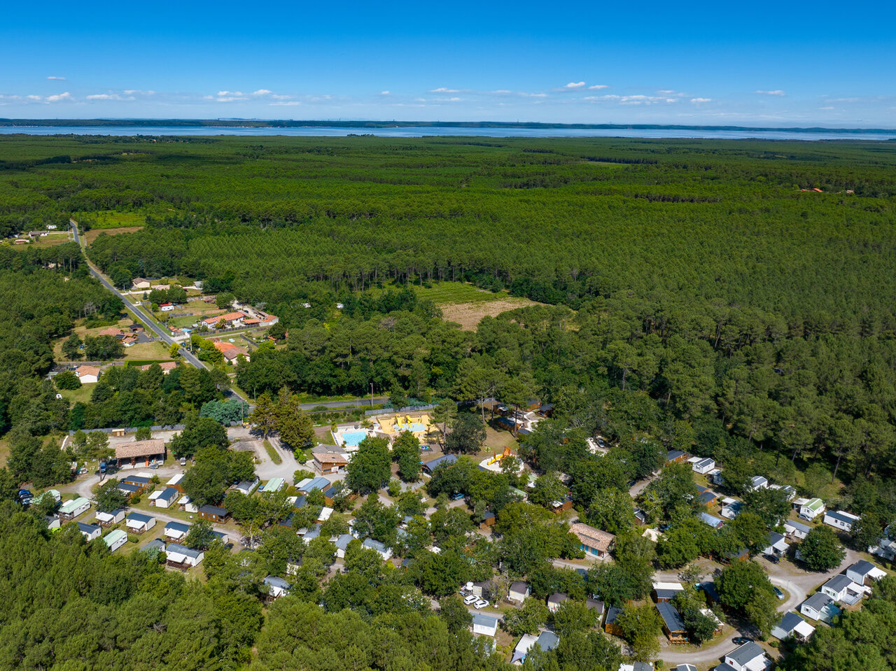 Aerial view campsite, mobile homes, swimming pool, forest at CLICOCHIC M�doc Bleu campsite in Carcans (33).
