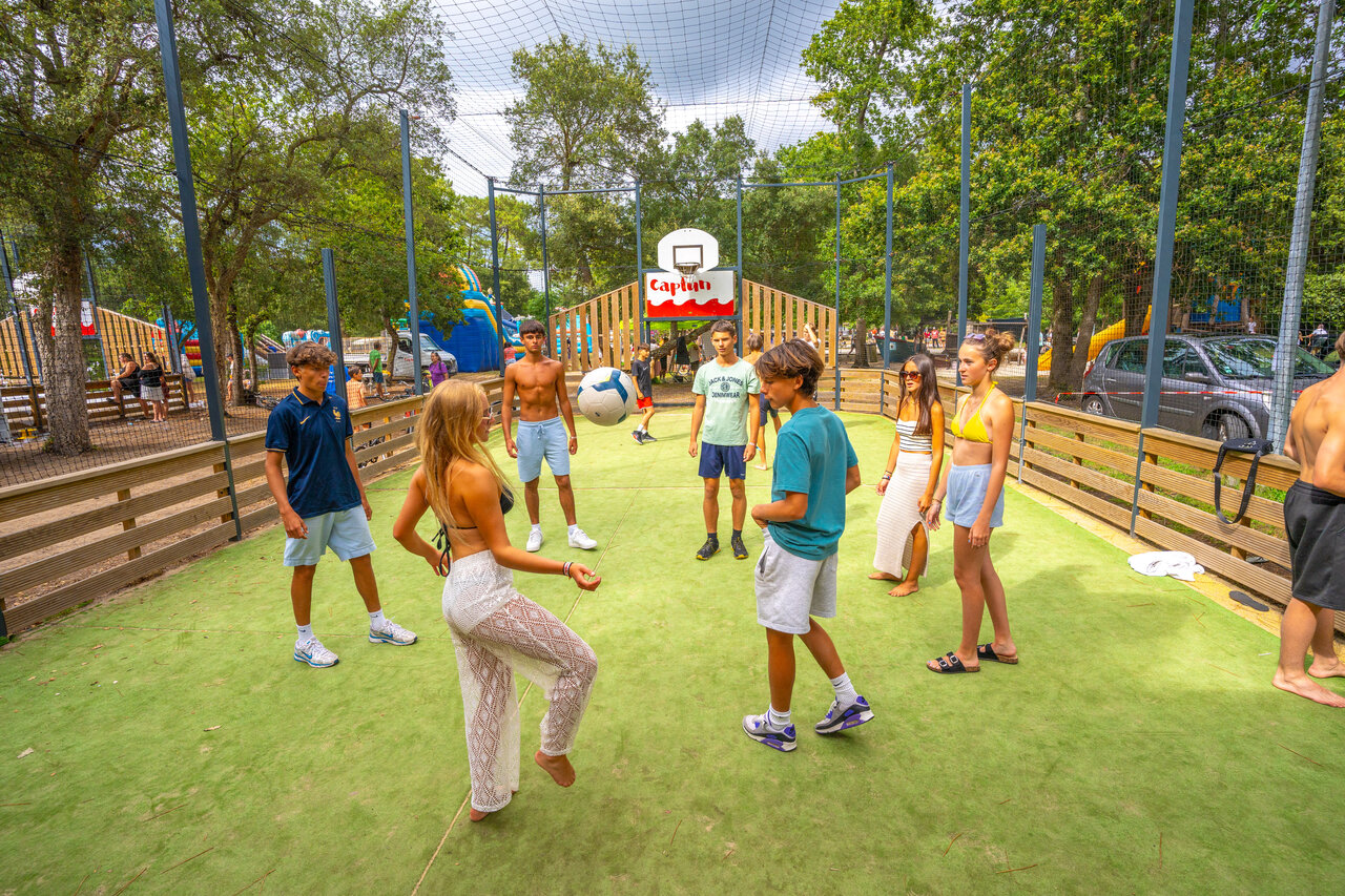 Young people playing football on Capfun multi-sport field, CAPFUN Mer Labenne-Oc�an.