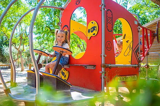 M�dchen auf farbenfrohem Spielplatz im Camping CAPFUN Mirmanda, Cambrils - Vinyols i els Arcs.