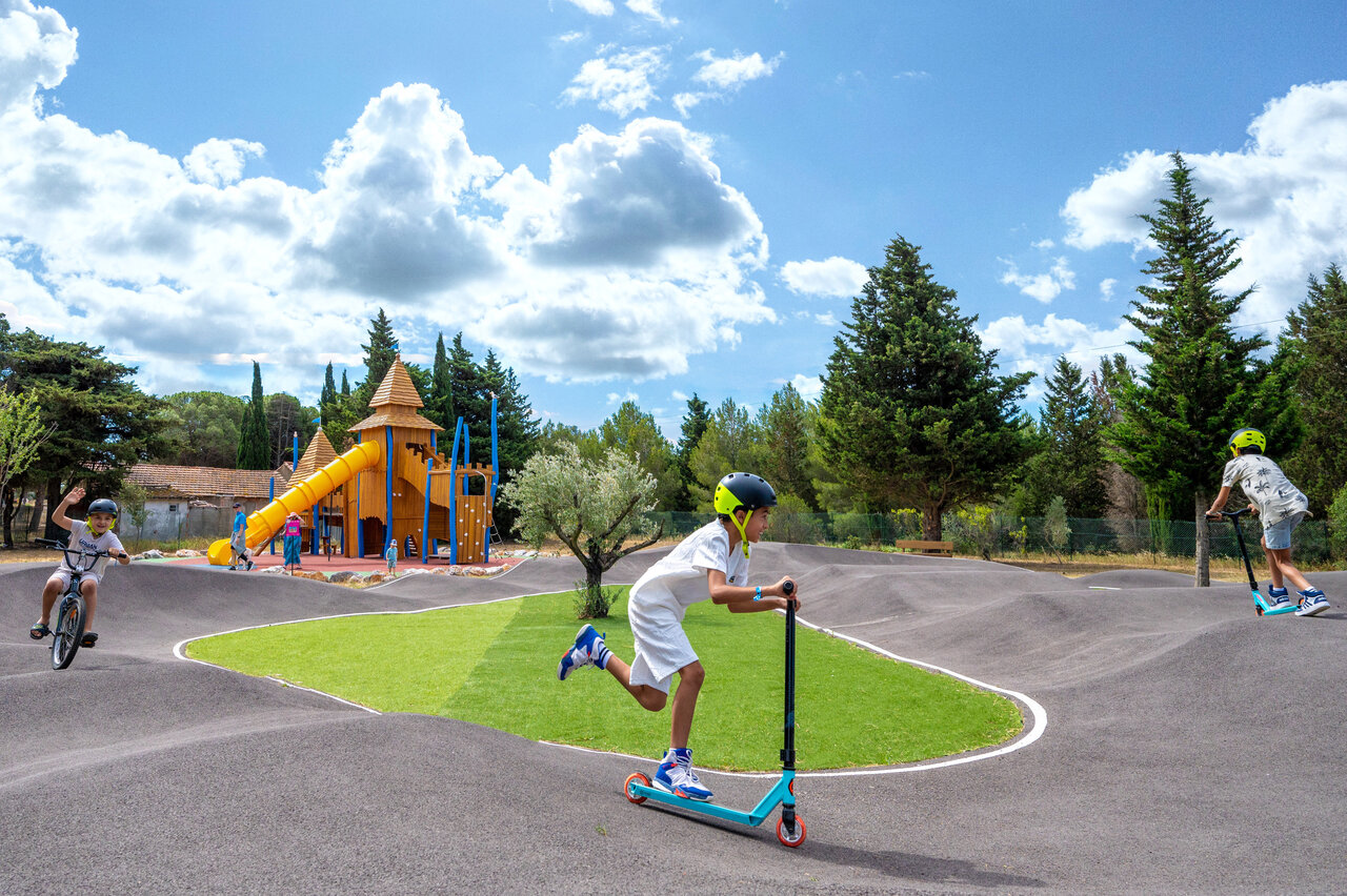 Children on pump track and playground at CAPFUN La Nautique campsite in Narbonne.