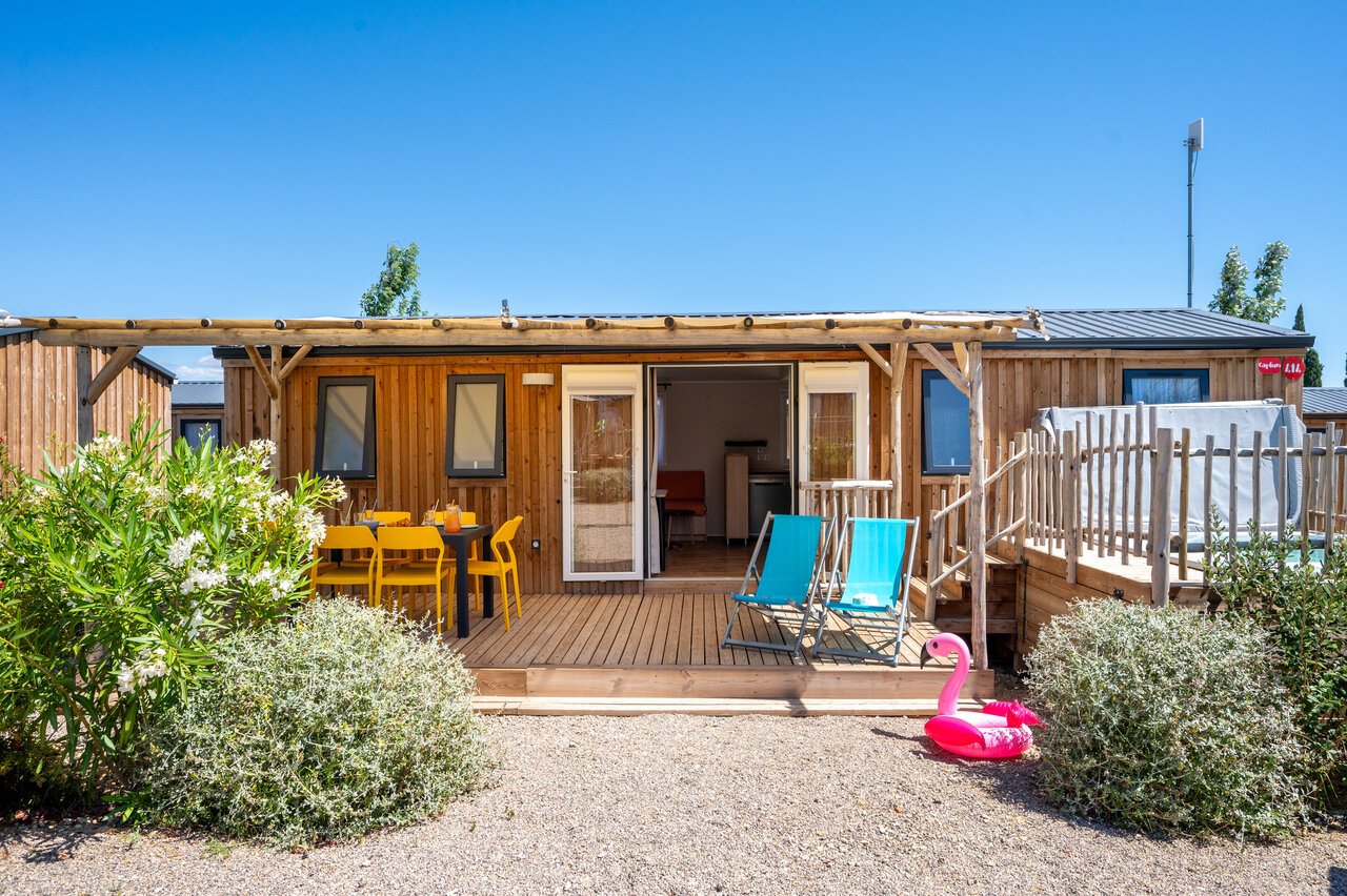 Wooden Mobile home with terrace, jacuzzi and outdoor furniture at CAPFUN La Nautique campsite.