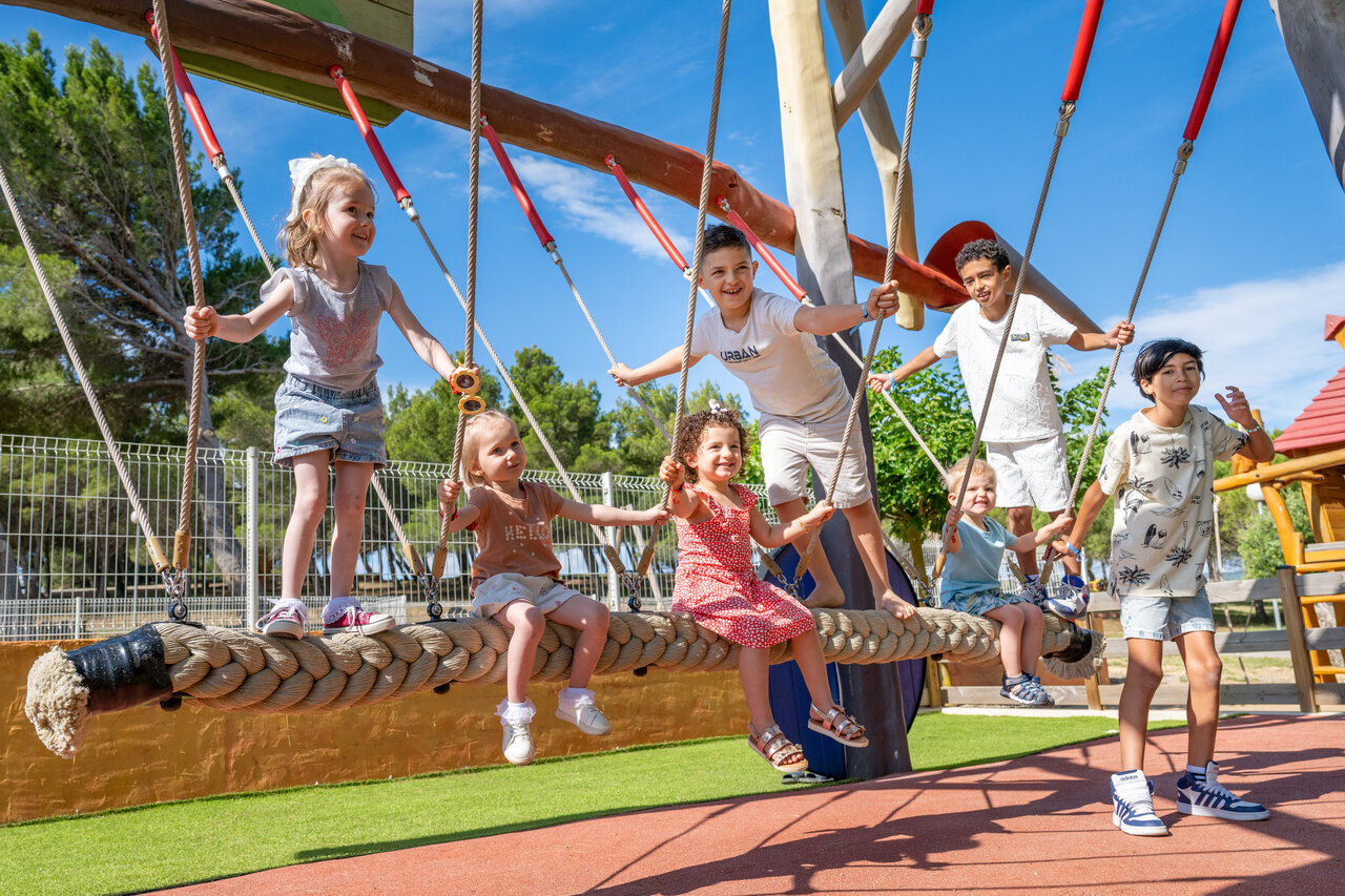 Children playing on rope swing at CAPFUN La Nautique campsite, Narbonne (11).
