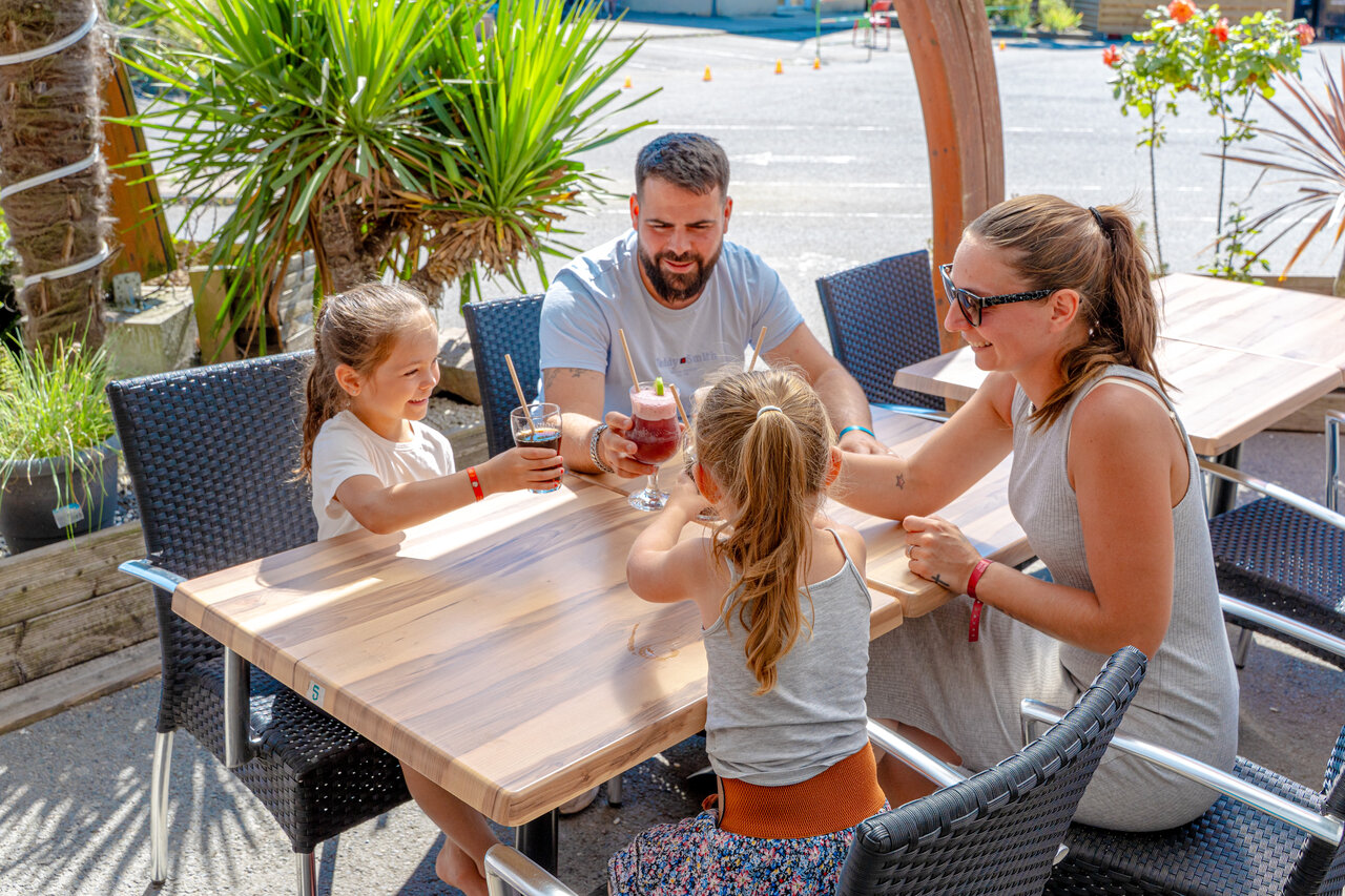 Familie genie�t die Au�enbar auf dem Campingplatz VAGUES OCEANES Odyss�e in Villers sur mer (14).
