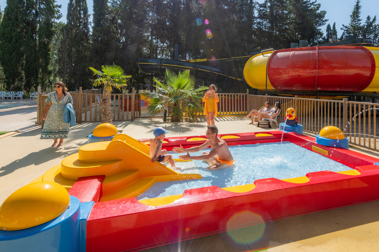 Buntes Kinderbecken mit Rutsche, Vater und Kind, auf Camping CAPFUN Or in La Grande Motte (34).