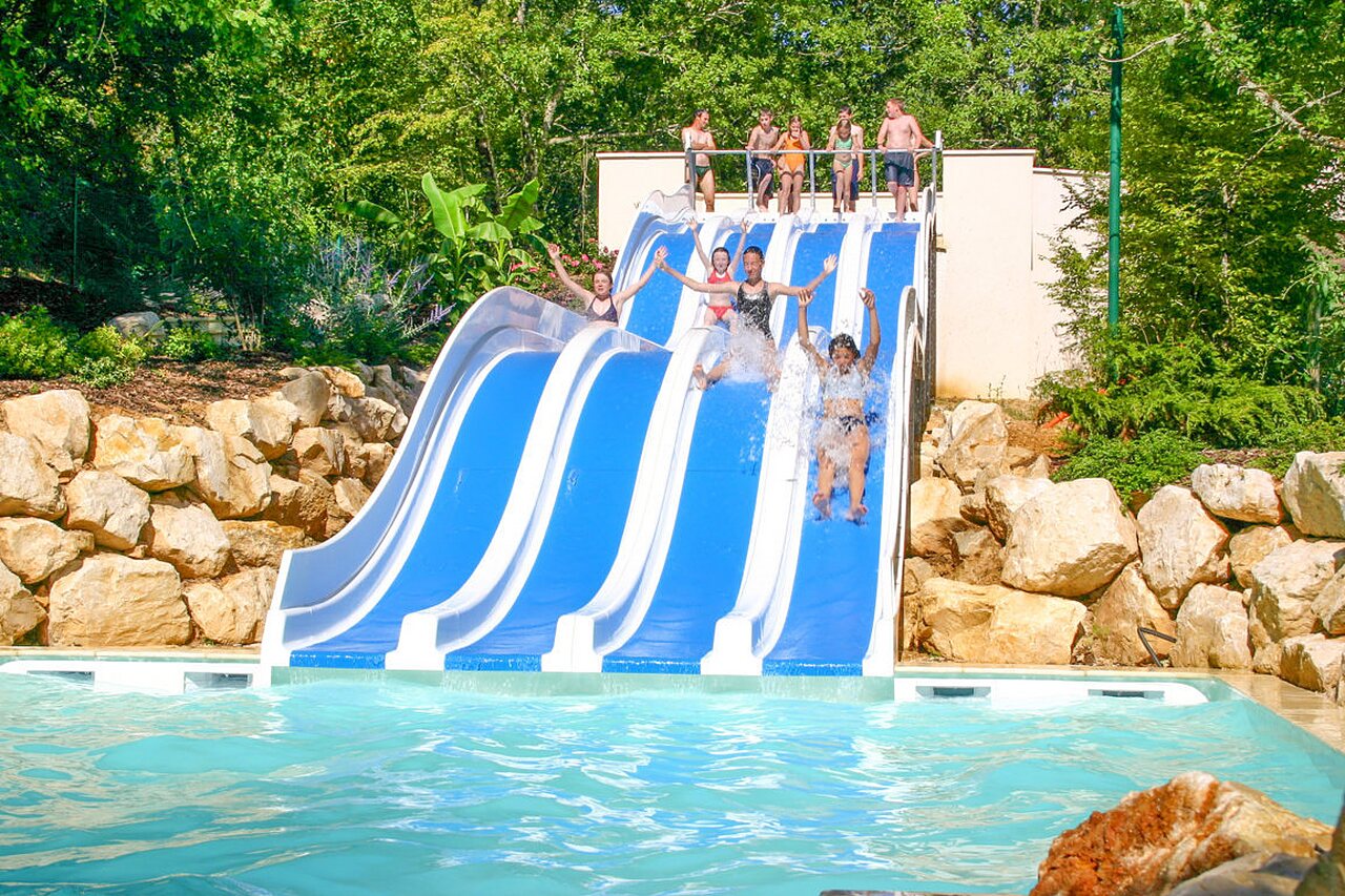 Piscina, toboganes en el camping VAGUES OCEANES Paille Basse, Souillac (46).