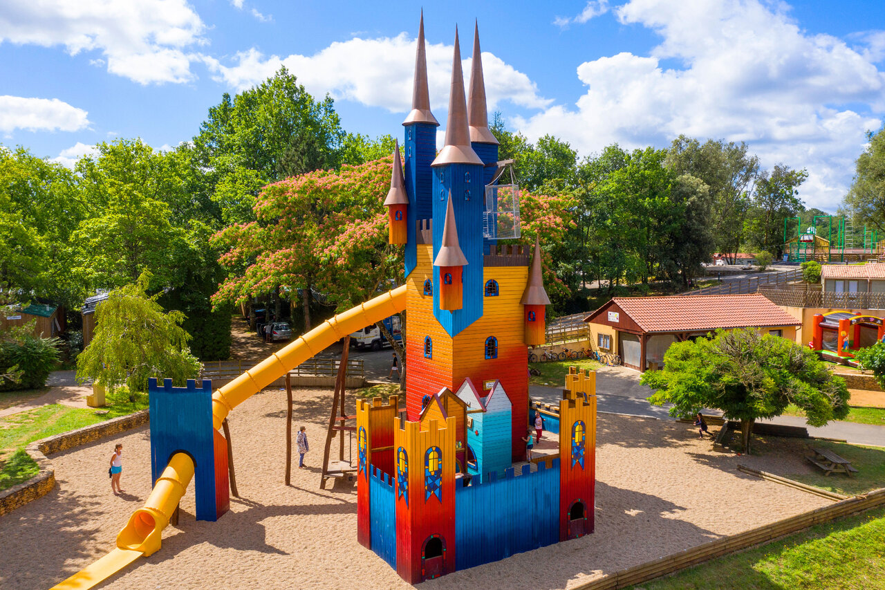 Colorful play castle with slides for children at CAPFUN Palombi�re campsite.