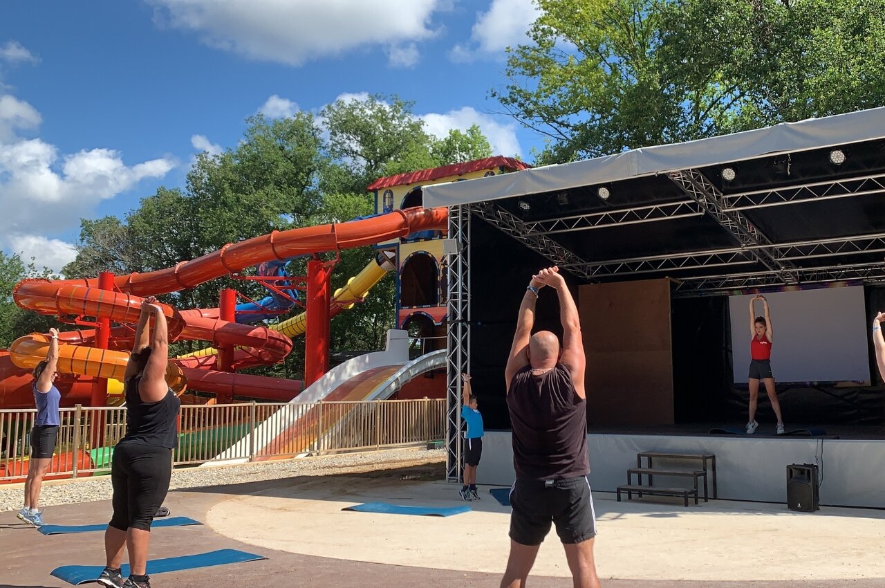 Outdoor sports class with water slides at CAPFUN Palombi�re campsite in Sarlat.