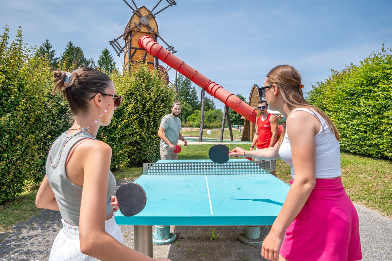 Young people playing outdoor table tennis, giant slide at CAPFUN Pergola campsite in Marigny.