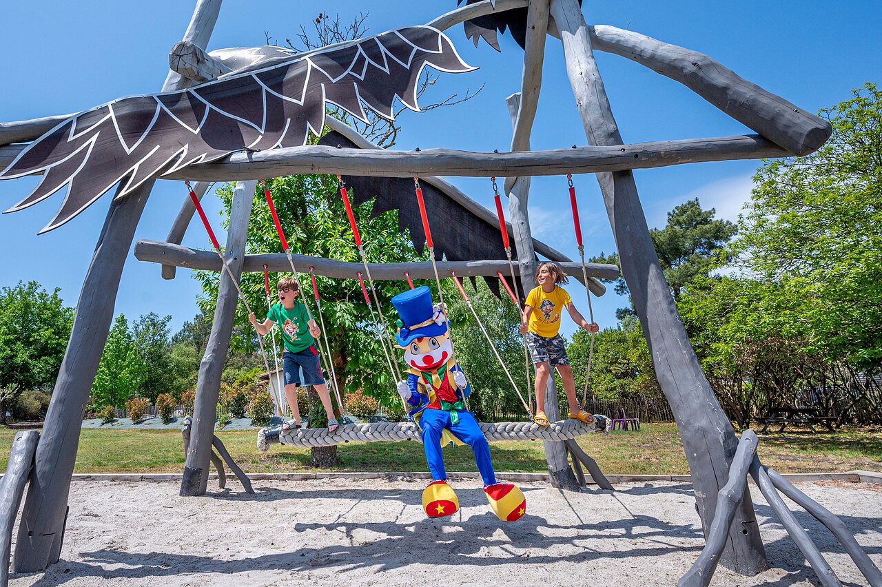 Giant swing with children and mascot at CAPFUN Pin�da campsite in CAZAUX (33).