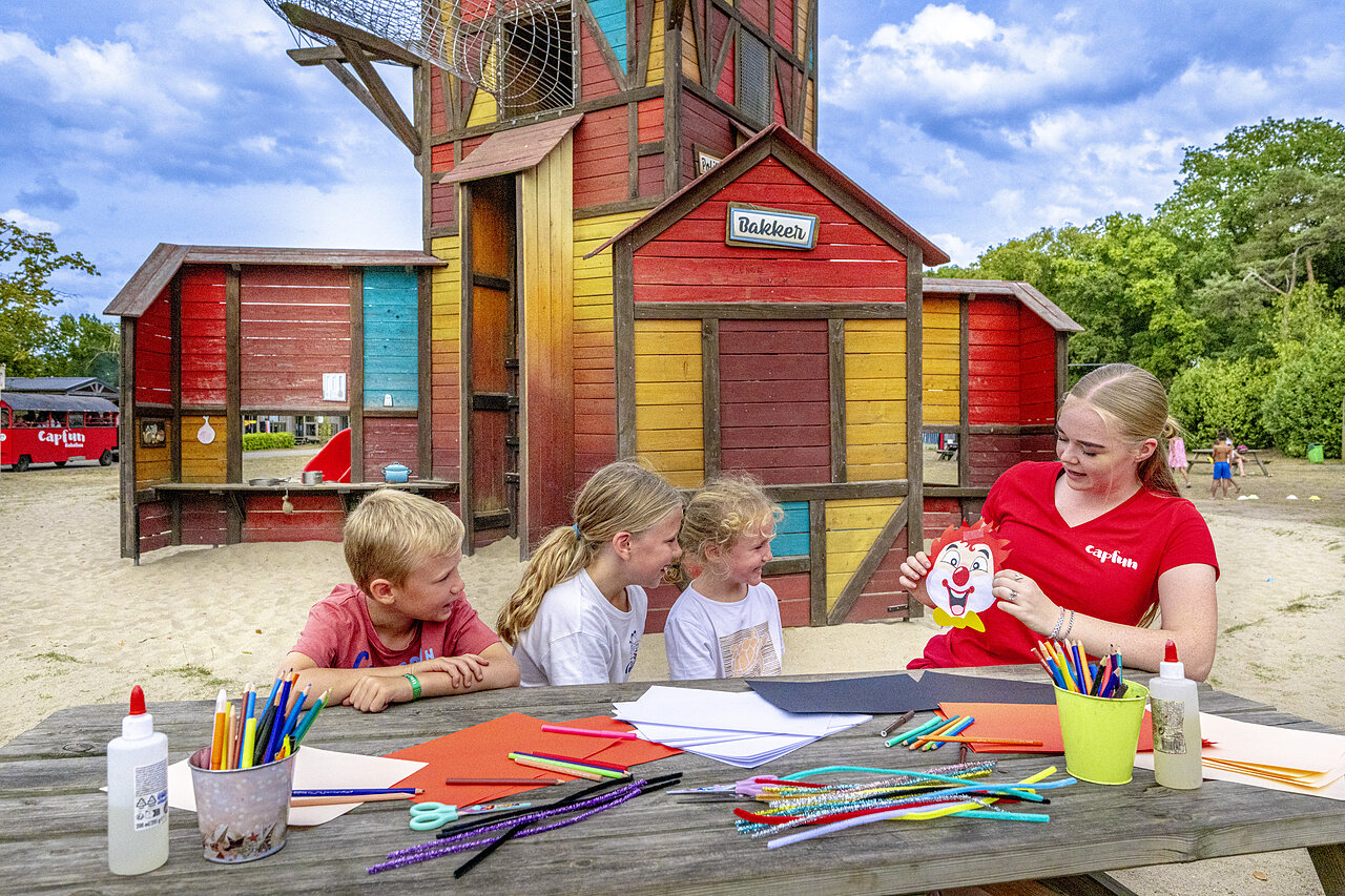 Kinder bei Kreativaktivit�t mit Capfun-Animateur auf Campingplatz CAPFUN Rakelbos in Westelbeers.