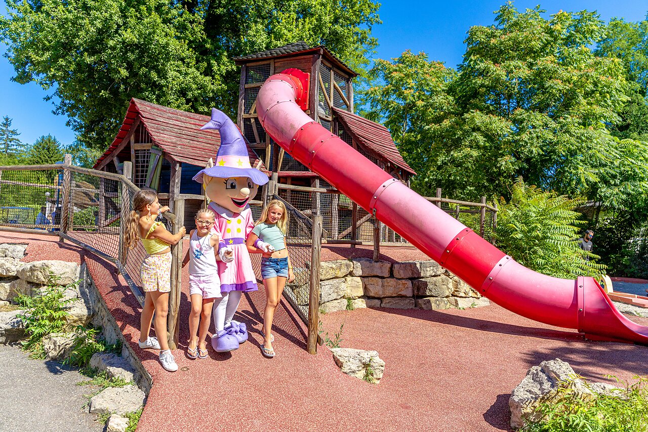 Children with mascot and giant slide at CAPFUN R�gni�re campsite in VILLETTE D'ANTHON (38).
