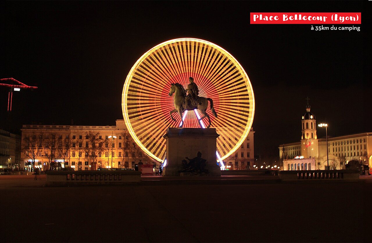 Place Bellecour in Lyon at night, illuminated Ferris wheel and equestrian statue.