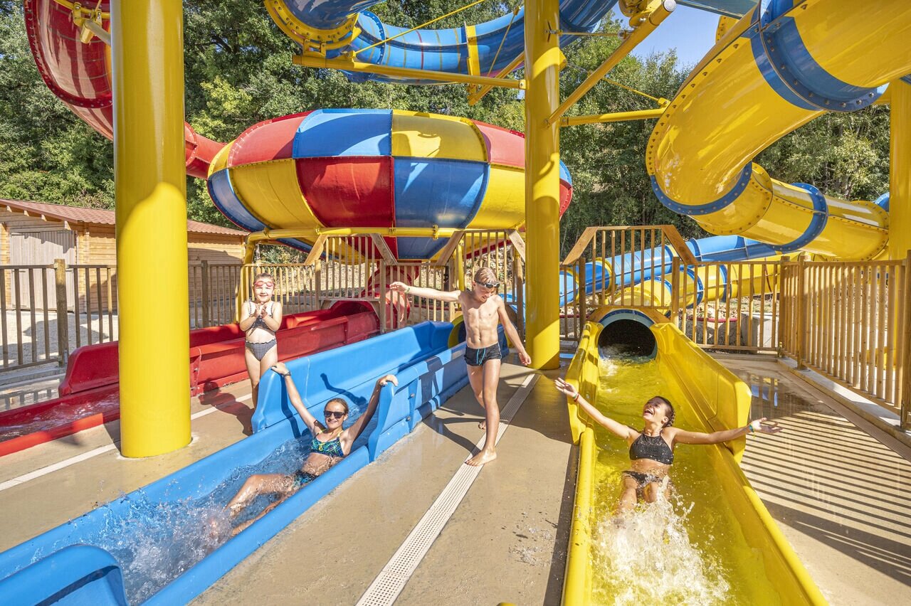 Children enjoying colorful water slides at CAPFUN La Rivi�re, Valence-en-Poitou (86).