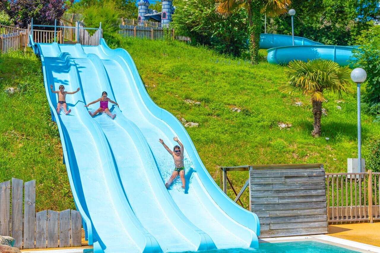 Children on giant water slide at CAPFUN La Rivi�re campsite, Valence-en-Poitou.