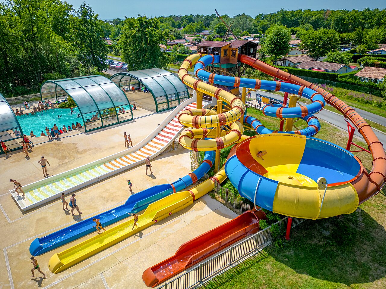Large water park with slides and covered pool at CAPFUN Roumingue campsite in LANTON (33).