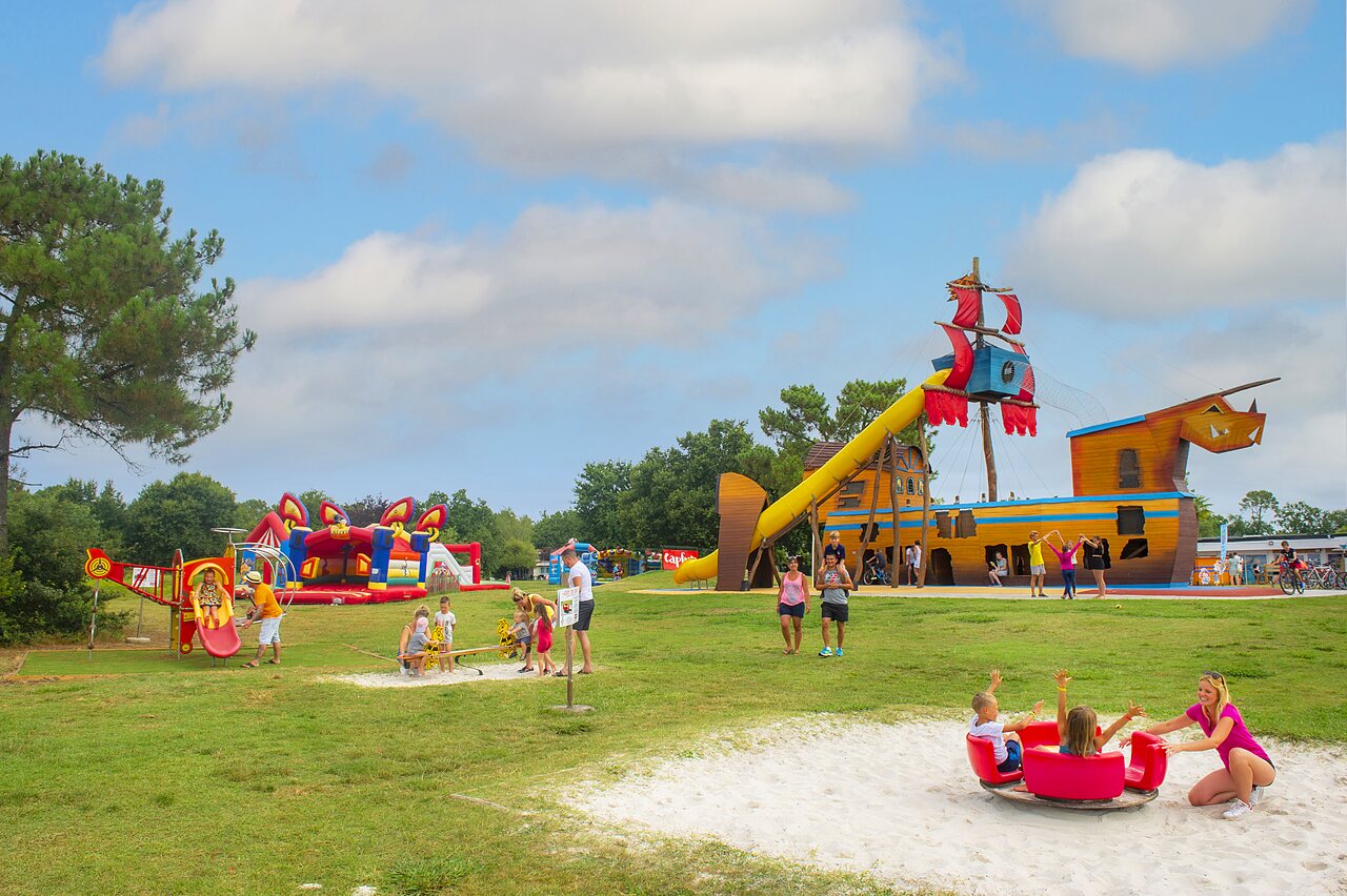 Large playground with pirate ship and slide at CAPFUN Roumingue campsite in LANTON (33).