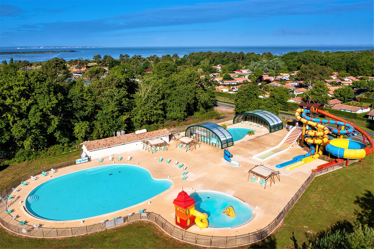 Outdoor pools, giant water slides at CAPFUN Roumingue campsite in LANTON (33).