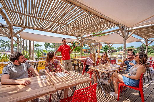 Belebtes Restaurantterrasse mit Kellner und Gästen auf Camping CAPFUN Roumingue in LANTON (33)