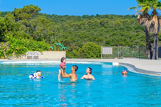 Famille avec b�b� jouant dans la piscine ext�rieure au camping CAPFUN La Rumba � Fr�jus (83).