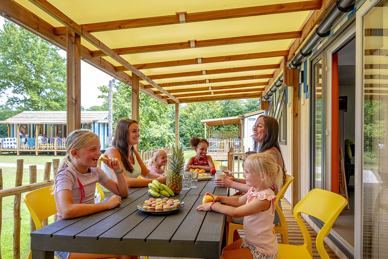 �berdachte Terrasse Mobilheim mit Familie auf dem Campingplatz CAPFUN Vakantiepark Capfun het Stoetenslagh in Rheezerveen.
