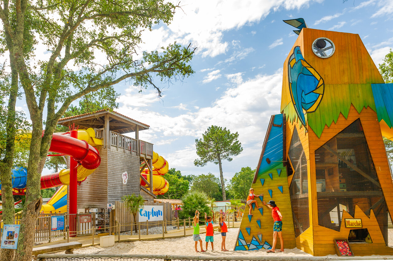 Colorful water slides and climbing wall for children at CAPFUN Sud Land campsite in Labenne-Ocean.