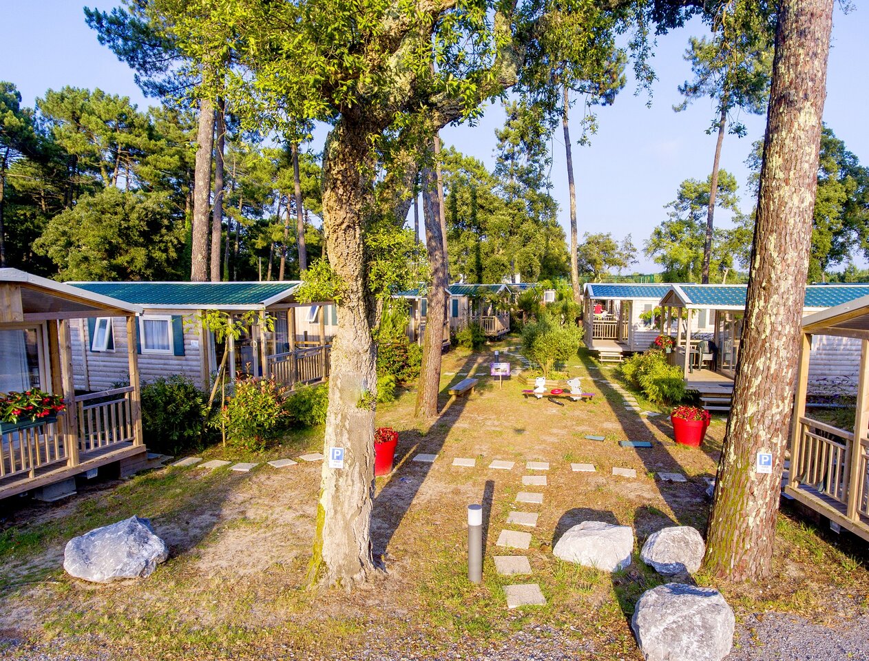 Comfortable Mobile homes among trees at CAPFUN Sud Land campsite in Labenne-Ocean.