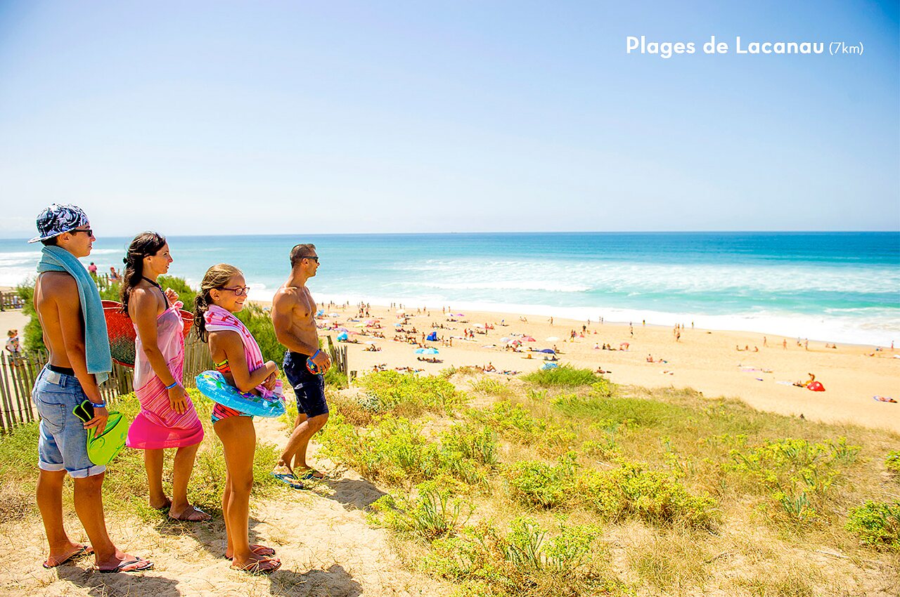 Family admiring the vast beaches of Lacanau, popular tourist destination in Gironde.