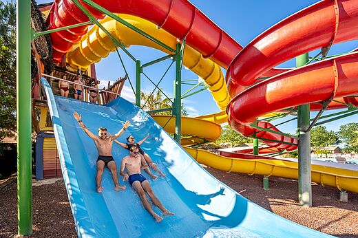 Kleurrijke waterglijbanen met vrienden die plezier hebben op camping CAPFUN Teorix in MARSEILLAN PLAGE (34).