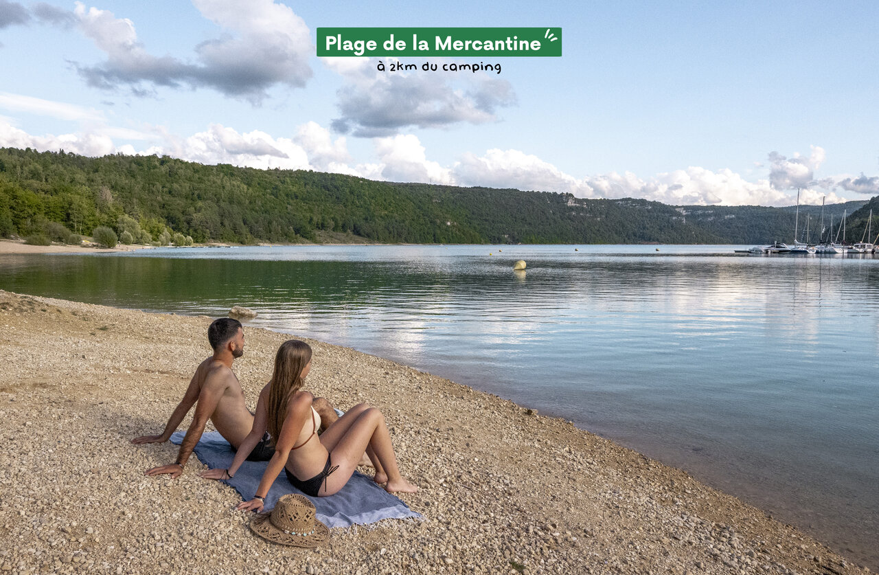 Couple relaxing on Plage de la Mercantine, a place to visit near the campsite.
