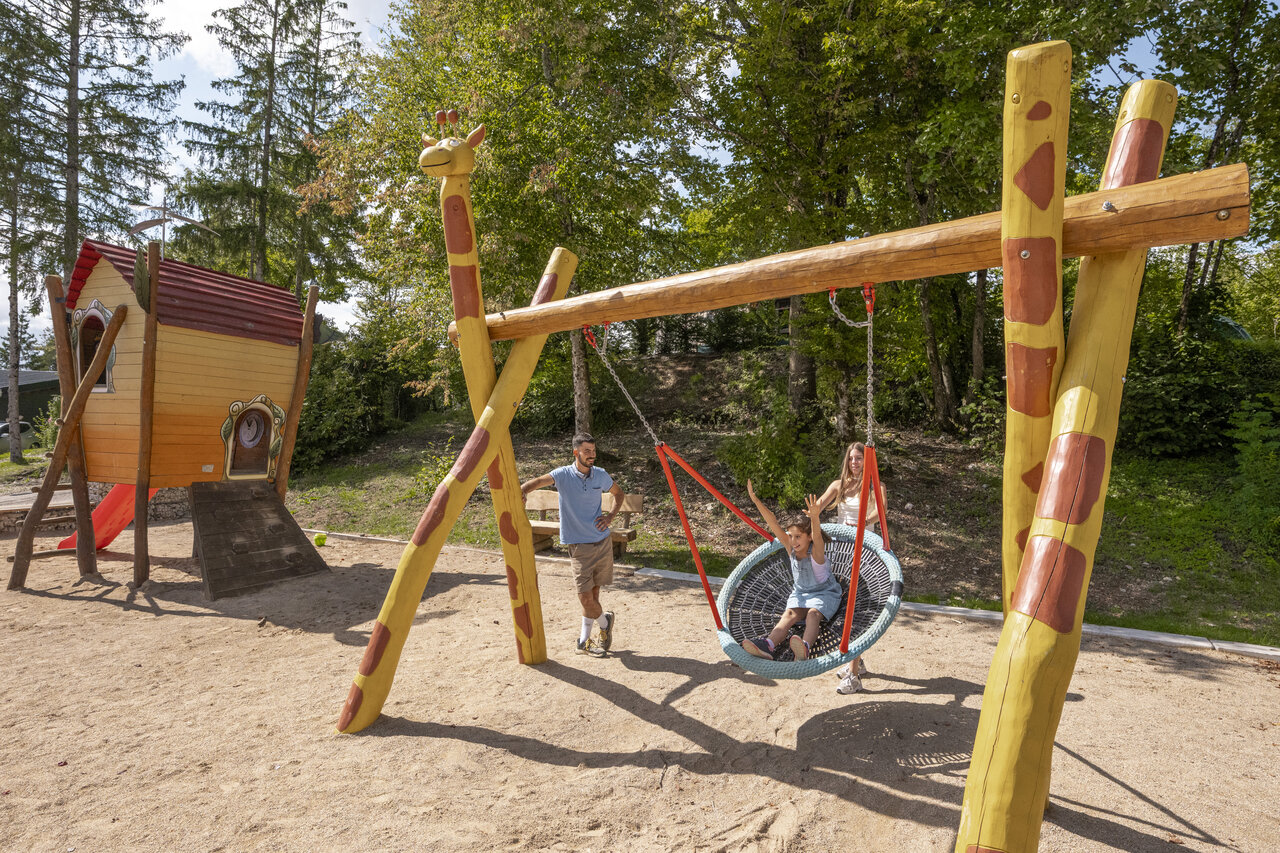 Playground, swing, playhouse at CLICOCHIC Trelachaume campsite in Maisod (39).