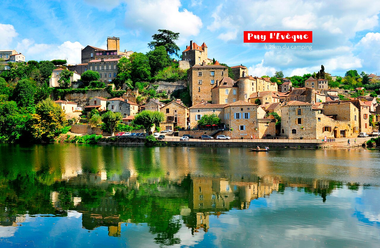 Medieval village of Puy L'�v�que reflected in the Lot river, near Tournon d'Agenais.