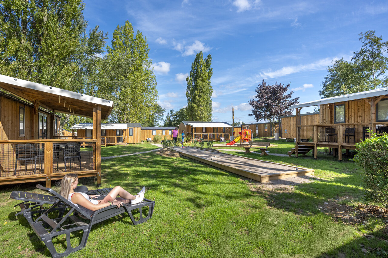 Mobile homes, petanque court and playground at CAPFUN Val d'Authie campsite in Villers sur Authie (80).