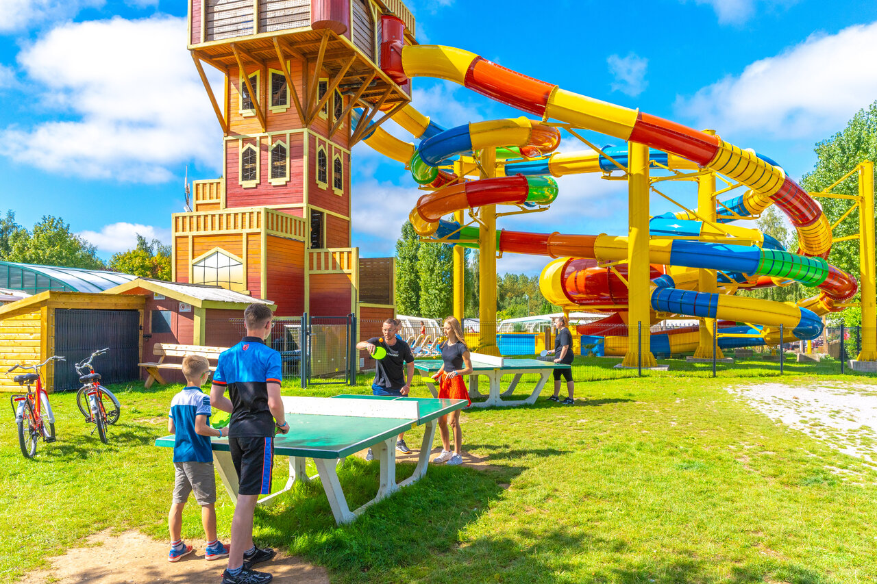 Colorful water slides and ping-pong tables at CAPFUN Val d'Authie campsite.