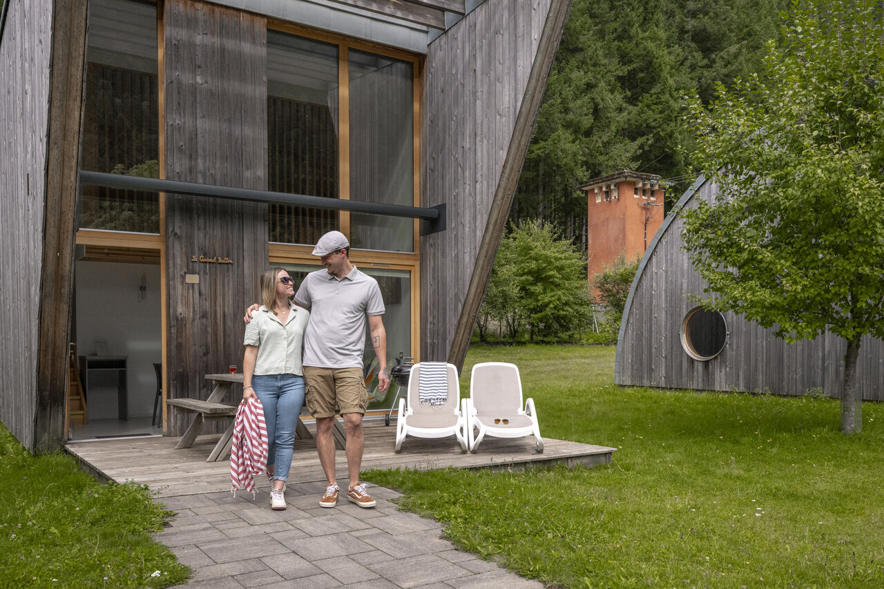 Couple devant un Mobil-home moderne en bois au camping CLICOCHIC Verte Vall�e � XONRUPT LONGEMER (88).