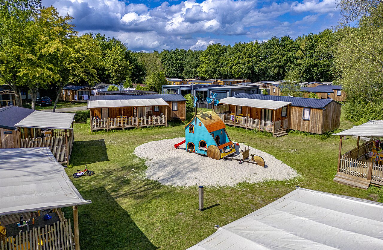 Bunter Spielplatz und Holz-Mobilheime auf dem Campingplatz CAPFUN Vlinderloo in Enschede.