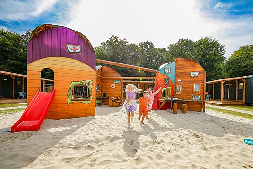 Kinder spielen auf einem Spielplatz mit Rutsche und Sand auf dem Campingplatz CAPFUN De Waldsang in Bakkeveen.