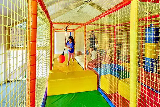 Indoor-Spielplatz mit Kind und Schaukelball auf dem Campingplatz CAPFUN Wieskamp in Winterswijk Henxel.