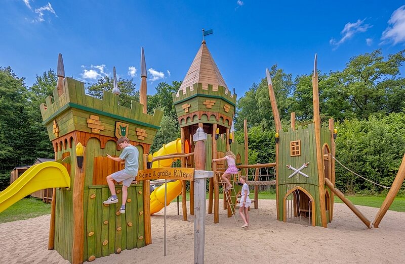Carabouille Spielplatz - H�lzerner Burgspielplatz mit Rutschen und Kindern auf dem Campingplatz CAPFUN het Winkel in Winterswijk.