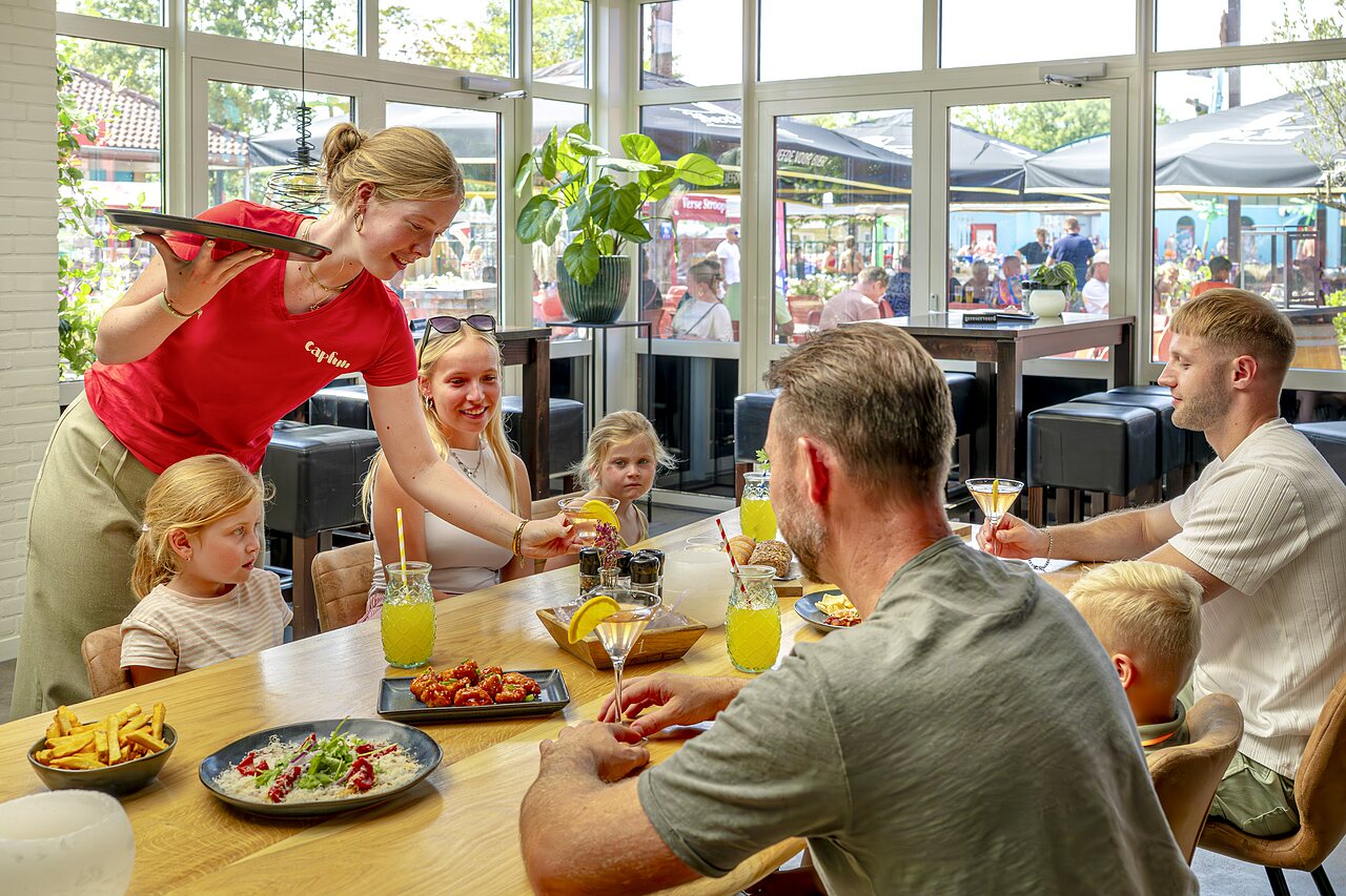 Familie speist im Restaurant des Campingplatzes CAPFUN Wondermolen in Molenschot.